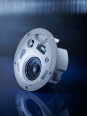 Mood shot of a white loudspeaker in dark blue light.